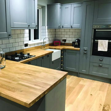 Rear extension with green shaker kitchen and metro tiles